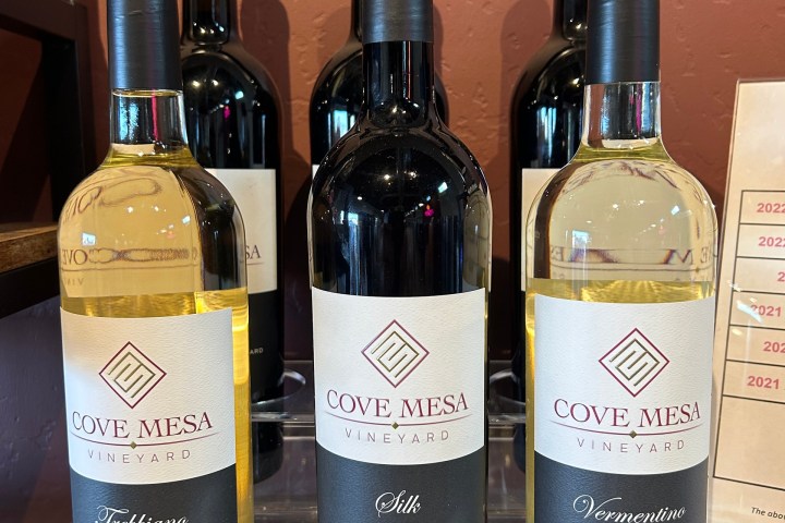 Three Cove Mesa wine bottles on display: Trebbiano, Silk, and Vermentino, all from 2022.