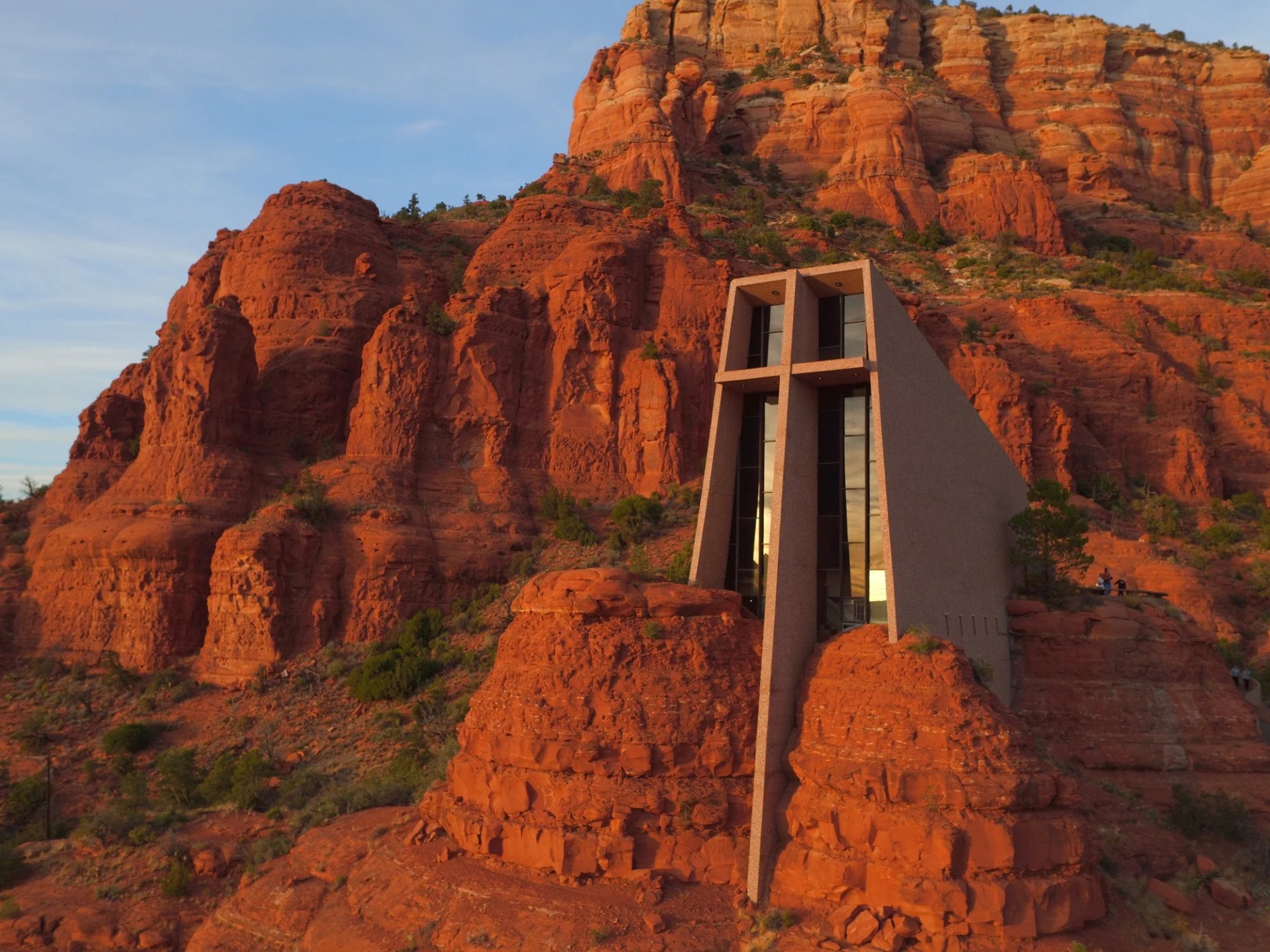 Modern chapel built into red rock formations at sunset in Sedona, Arizona.